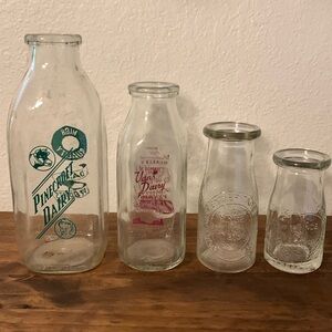 Four vintage milk bottles